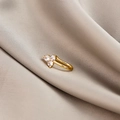 Close-up of gold nose cuff with three clear cubic zirconia stones on silk background - Clover (E5689-6)