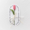 Detail of hand-knitted pink tulip with green stem and Love Is Eternal ribbon - Closed Tulip - Dark Pink