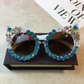 White cat-eye sunglasses with blue rhinestones, pink gems, and decorative bee accents - White Frame / Water Blue Rhinestone