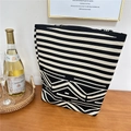 Detail of a black and white knit tote bag with geometric patterns on a wooden table - 6 Wave Pattern Black