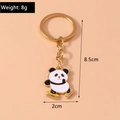 Detail of cute panda skating keychain with dimensions 8.5x2cm and weight 8g on orange background - Skating Panda Keychain