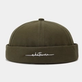 Close-up of olive green vintage brimless docker hat with white script embroidery - Adjustable / Army Green
