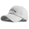 Close-up of black 'bad hair day' embroidery on a white cotton baseball cap surface - One Size / White