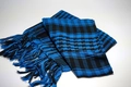 Detail of blue and black checkered desert scarf featuring decorative fringe tassels - Sky Blue