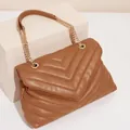 Brown quilted V-pattern shoulder bag with golden chain straps and soft faux leather finish - Brown