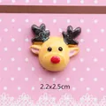 Macro shot of 2.2x2.5cm Christmas reindeer resin flatback charm with glitter details - Yellow Deer Head