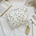 Detailed texture of white floral makeup bag with red roses and fringe tassel surface - Lace Red Rose