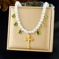 Detail of a pearl necklace featuring a gold cross pendant and green emerald-cut charms - Green Gemstone Cross Style (N3733)