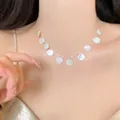 Close-up of minimalist silver chain necklace with white shell disc pendants on model - 26# Silver Round Shell Texture Necklace