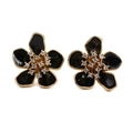 Detailed macro view of black enamel flower earrings with gold plating and sparkling crystals - Black