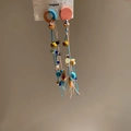 Close-up of Bohemian fish shell tassel earrings with colorful beads and ethnic woven design - 925 Sterling Silver Earring Post Multicolor Wood Bead Tassel