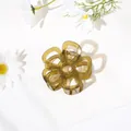 Detailed top view of an olive green translucent resin flower claw clip with gold spring - Hollow Five-Petal Flower - Jelly Green