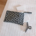 Detailed view of butterfly print canvas clutch bag and checkered hair claw clip - Black Heart Pattern