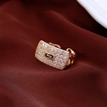 Macro shot of gold rectangle chain ring with pavé zircons on dark red silk fabric - Gold