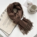 Brown cashmere feel knit scarf with tassels laid on white table with coffee cup - Tea Brown