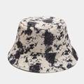 Close-up of off-white canvas bucket hat showing black ink splatter texture and reinforced seams - M (56-58cm) / Black
