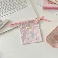 Macro shot of a light pink cotton drawstring pouch featuring cute blue cat prints and tag - Printed Cat Pink