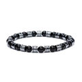 Close-up of black volcanic beads and silver cylindrical metal spacers on beaded bracelet - 6mm Hematite and Polished Stone