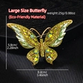 Macro shot of large butterfly brooch with emerald green crystals and golden alloy detail - Large Butterfly Green (YNCP5960)