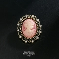 Detail view of a vintage cameo brooch with pink relief and gold frame measuring 3.0cm by 3.6cm - Pink Portrait Hollow Lace Style (XD7383-1)