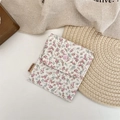 Floral fabric storage pouch with pink snap button and side label on a rustic background - Large Pink