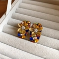 Macro detail of gold flower earrings with colorful rhinestones and small center pearls - Gold 3D Multicolor Rhinestone Flower Style