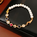 Detail of vintage heart bracelet with multi-color zircon and pearls on black leather - Gold-White (18K Gold Plated)