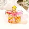Macro detail of gradient yellow and pink plumeria hair claw clip with iridescent finish - Transparent Yellow Pink