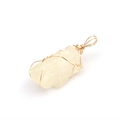Close-up of a raw yellow crystal stone pendant with handmade gold wire wrapping - Citrine
