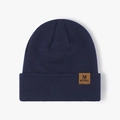 Navy blue ribbed knit beanie featuring a brown leather patch with a letter M logo - One Size / Navy Blue