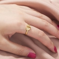 Fashionable golden broken heart open ring with crystals worn on a hand over satin - Gold Heart Crossover