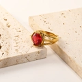 Detailed view of an 18K gold plated hollow ring featuring a round red zircon gemstone - Gold Plated Rose Red Zirconia