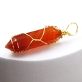 Detail of handcrafted gold wire wrapped around a hexagonal orange agate stone pendant - Red Agate