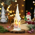 Close-up of white LED church light on a wooden base with winter scenery and bokeh lights - White Snowman