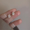 Vintage style gold oval stud earrings with clear zircon stones held in hand - Oval Gold Edge Zircon