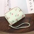 Mint green cherry print wallet with gold clasp and wrist strap on a wooden desk - 9 Card Slots + 2 ID Windows + Button Compartment / Light Green