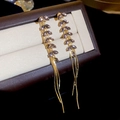 Dettaglio di orecchini a nappa dorati con cristalli marquise viola-grigio su portagioie - Oro-Zirconia Viola (925 Sterling Silver Perno per orecchini)