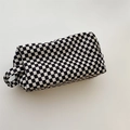 Detail of the checkered velvet makeup bag showing textured fabric and side handle grip - Small Black Plaid