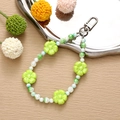 Detail of green acrylic flower beads and faux pearls with a silver metal clasp - Green