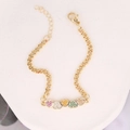 Close-up of golden bracelet featuring heart pendants with colorful inlaid crystals - Pave Five Color Hearts (21#)