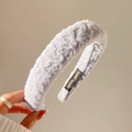 Pale blue pleated fabric wide headband with a handmade label shown in a lifestyle view - Sky Blue