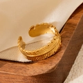 Detailed close-up of a 18k gold-plated stainless steel leaf feather open ring - Leaf Gold 85