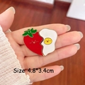 Detail of creative enamel heart brooch featuring strawberry and egg puzzle design - Tomato and Fried Egg Pair