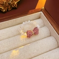 Close-up of pink crystal bow ring on a velvet jewelry box with warm lighting - Pink Bowknot with Transparent Beads