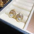 Macro view of gold-plated leaf earrings featuring small zircon stones and white pearls - Leaf Shape(HE29758) / Gold-White