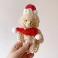 Beige plush teddy bear keychain wearing a red and white knitted Christmas hat and scarf - Brown Bear With Red Accessories