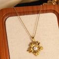 Golden necklace featuring a flower pendant with a white pearl center on a vintage background - Gold Pearl Flower Pendant Necklace