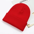 Close-up macro detail of a vibrant red knitted beanie winter hat on white background - One Size / Red