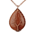 Macro shot of goldstone teardrop pendant with Tree of Life wire wrapping detail - Goldstone Antique Bronze