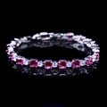 Detailed macro view of silver bracelet with square pink zircons and clear gems - Rose Red